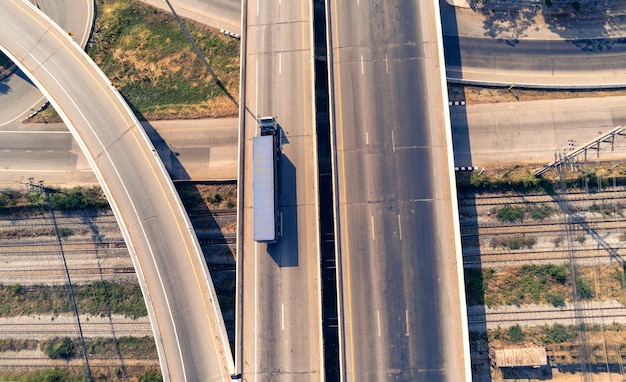 Photo aerial view of cargo truck on highway road with blue container, transportation concept.,import,export logistic industrial transporting land transport on the asphalt expressway