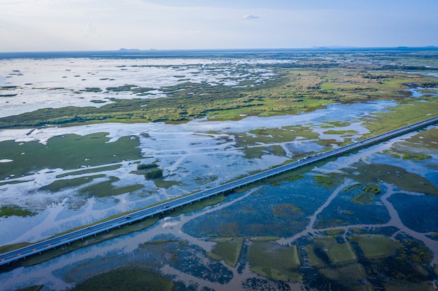 Aerial view of Chalerm Phra Kiat road at daytime in Thale Noi, Phatthalung, Thailand