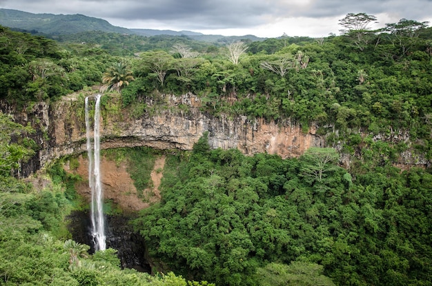 Aerial view of the Chamarel Waterfall surrounded by lush trees in Mauritius