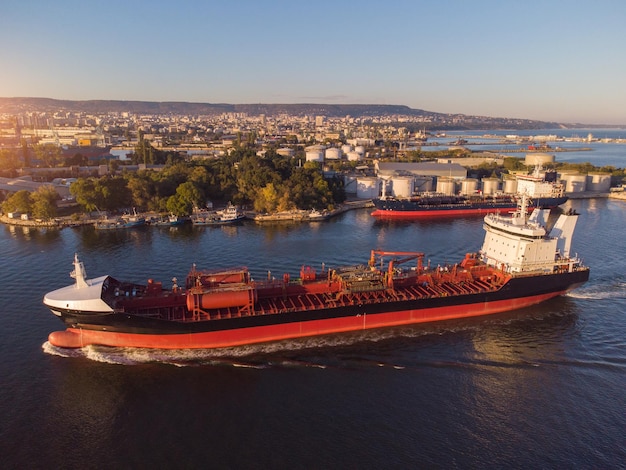 Aerial view of Chemical industry storage tank and tanker ship entering to the oil terminal