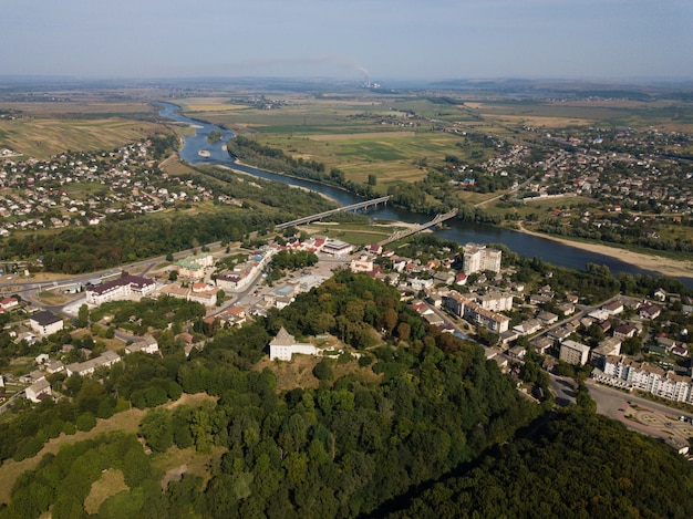 Aerial view of city Halych with ruined castle on hill, river and horisont