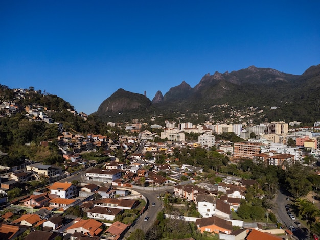 Aerial view of the city of Teresopolis Mountains and hills with blue sky and many houses in the mountain region of Rio de Janeiro Brazil Drone photo Araras Teresopolis Sunny day Sunrise