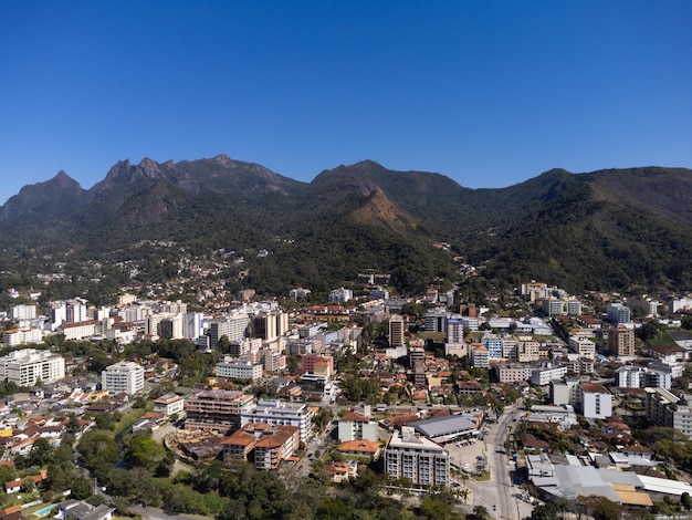 Aerial view of the city of Teresopolis Mountains and hills with blue sky and many houses in the mountain region of Rio de Janeiro Brazil Drone photo Araras Teresopolis Sunny day Sunrise