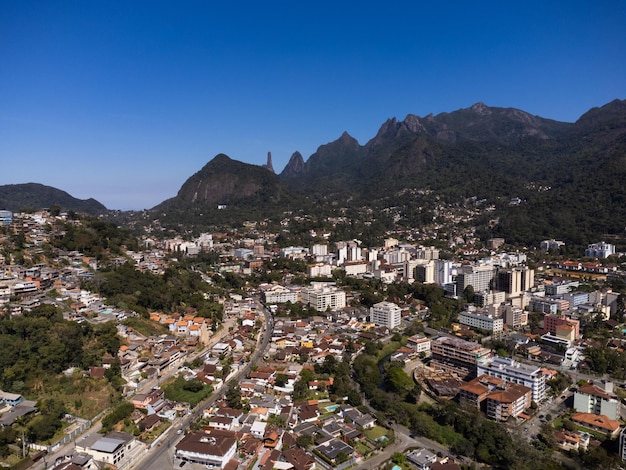 Aerial view of the city of Teresopolis Mountains and hills with blue sky and many houses in the mountain region of Rio de Janeiro Brazil Drone photo Araras Teresopolis Sunny day Sunrise