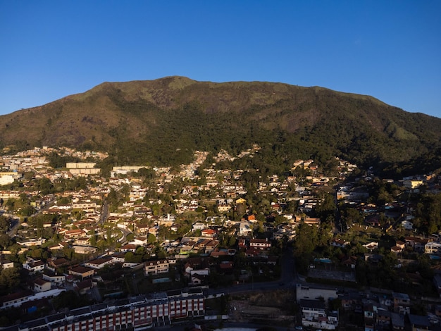 Aerial view of the city of Teresopolis Mountains and hills with blue sky and many houses in the mountain region of Rio de Janeiro Brazil Drone photo Araras Teresopolis Sunny day Sunset