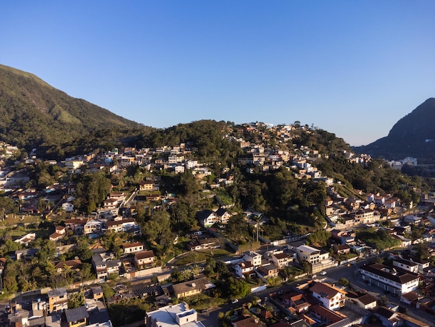 Aerial view of the city of Teresopolis Mountains and hills with blue sky and many houses in the mountain region of Rio de Janeiro Brazil Drone photo Araras Teresopolis Sunny day Sunset