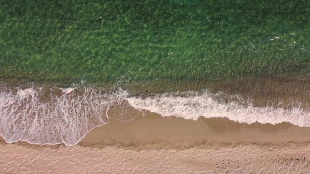 Aerial view of clear turquoise sea and waves