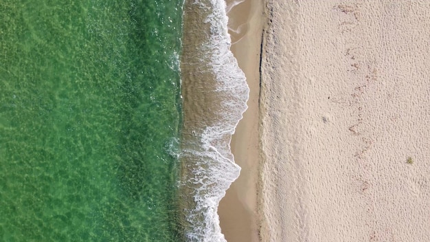 Aerial view of clear turquoise sea and waves