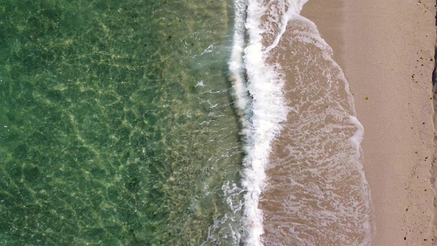 Aerial view of clear turquoise sea and waves