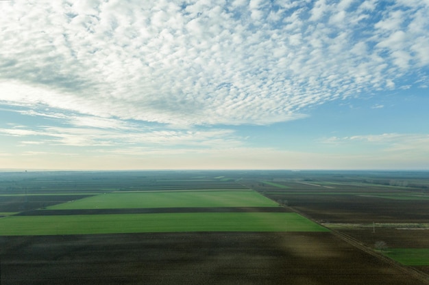 Aerial view Clouds over over green agricultural fields.