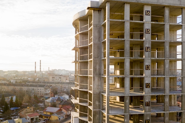 Aerial view of concrete frame of tall apartment building under construction in a city