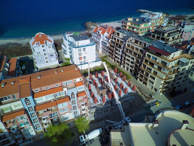 Aerial view of the construction of apartments in the area with streets and cars near the Black Sea in Pomorie Bulgaria