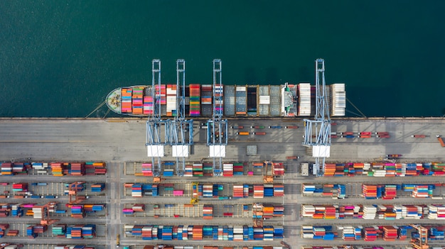 Aerial view container ship carrying container in import export business logistic and transportation.