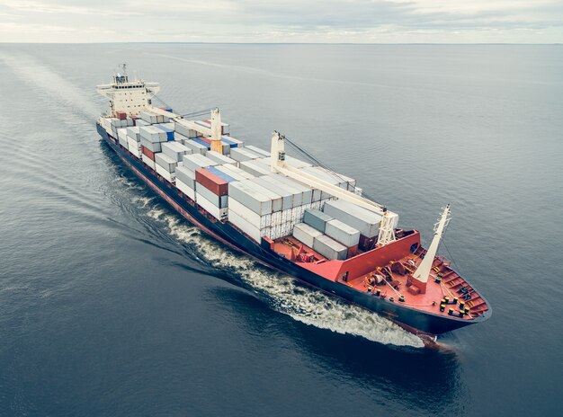 Aerial view of container vessel sailing in open sea