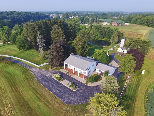 Aerial View of Countryside Estate with White Barn and Pond in Indiana