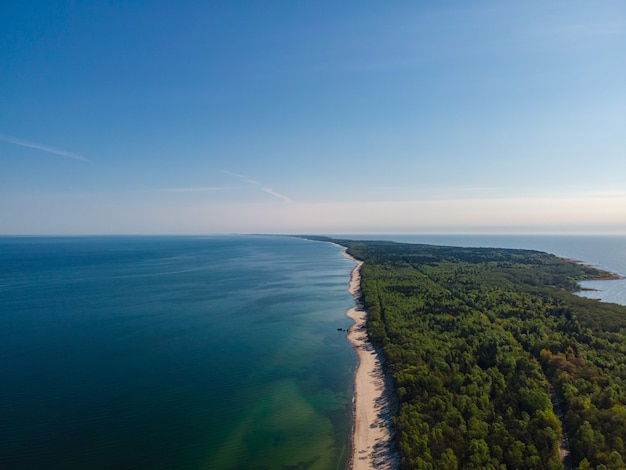 Aerial view of Curonian spit with sandy beach, sea and forest on Baltic sea, Kaliningrad region, Russia