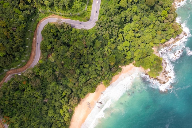 Aerial view of curve road along the seashore at Phuket Thailand beautiful seacoast and open sea in summer season Nature recovered Environment and Travel background