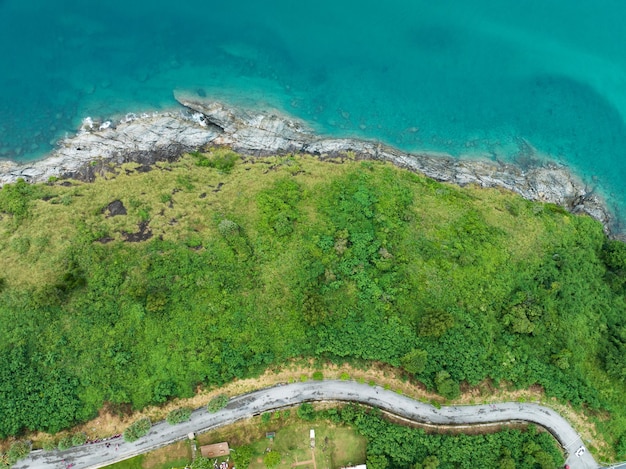 Aerial view of curve road along the seashore at Phuket Thailand beautiful seacoast and open sea in summer season Nature recovered Environment and Travel background