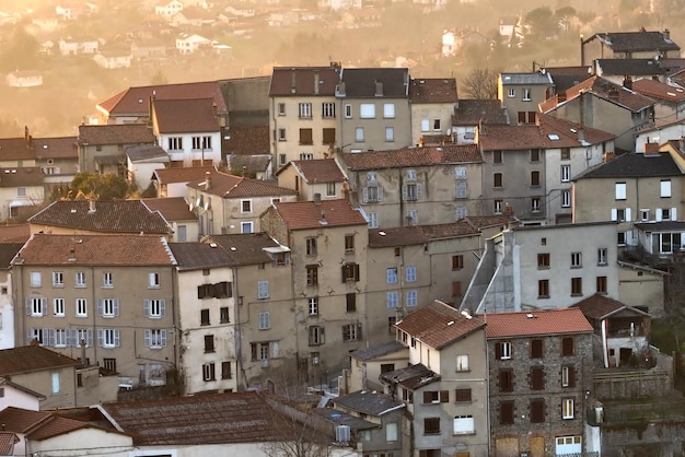 Aerial view of dense historic center of Thiers town in PuydeDome department AuvergneRhoneAlpes region in France Rooftops of old buildings and narrow streets at sunset