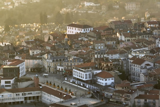 Aerial view of dense historic center of Thiers town in PuydeDome department AuvergneRhoneAlpes region in France Rooftops of old buildings and narrow streets at sunset