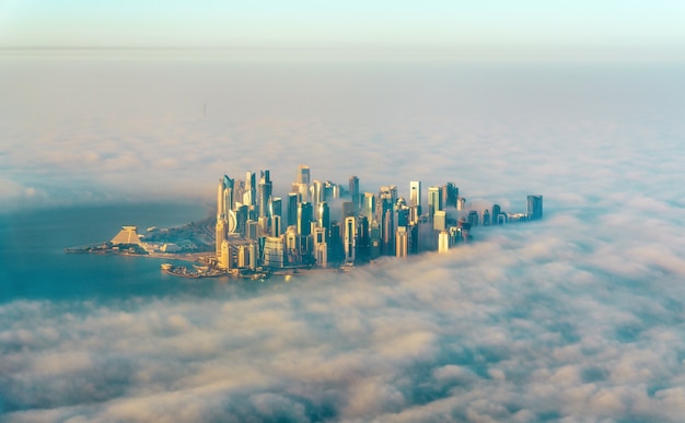 Aerial view of Doha through the morning fog, the capital of Qatar in the Persian Gulf