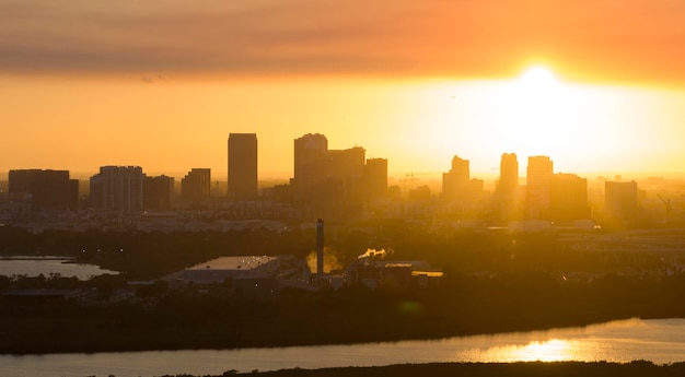 Aerial view of downtown district of Tampa city in Florida USA at sunset Dark silhouette of high skyscraper office buildings in modern american midtown