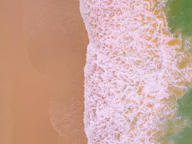 Aerial view drone over beach sea Beautiful sea waves background Beach sand sea surface Summer season seascape at Phuket island Thailand High angle view Top down