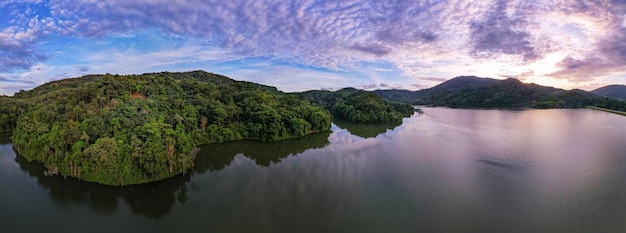 Aerial view drone shot of panorama abundant rainforest Sunset or sunrise sky over lakeBeautiful landscape nature mountains view in phuket thailand