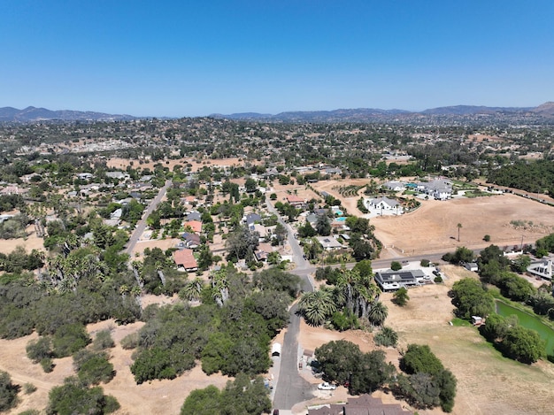 Aerial view of dry valley and land with houses and barn in Escondido, San Diego, California