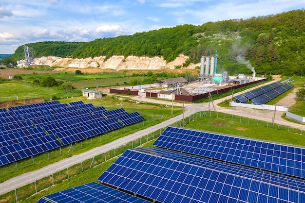 Aerial view of electrical power plant with rows of solar photovoltaic panels for producing clean ecological electric energy at industrial area. Renewable electricity with zero emission concept.