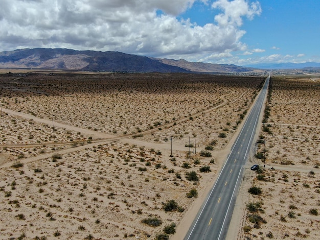 Aerial view of endless desert straight road next Joshua Tree Park USA Long straight tarmac road