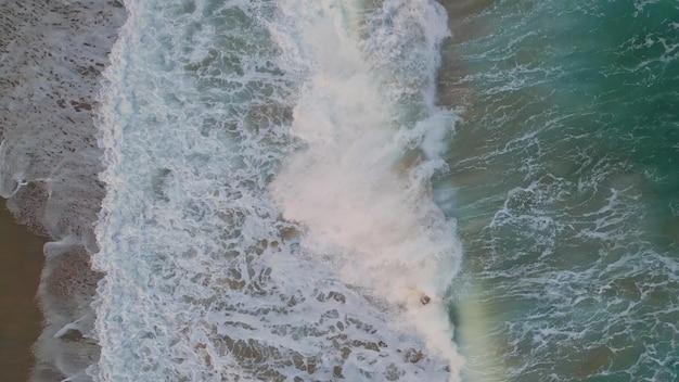 Aerial view foaming sea water splashing rolling top shot waves washing seashore