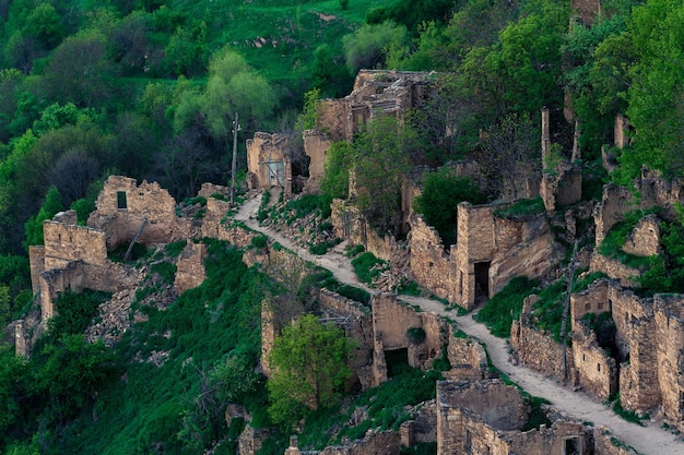 Aerial view of the former street among the ruins in the abandoned mountain village of gamsutl in Dagestan