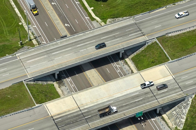 Aerial view of freeway overpass junction with fast moving traffic cars and trucks Interstate transportation infrastructure in USA