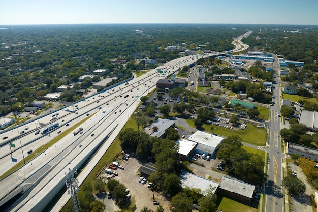 Aerial view of freeway overpass junction with fast moving traffic cars and trucks Interstate transportation infrastructure in USA