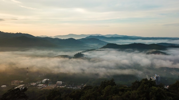 Aerial view from drone beautiful mist over forest and village