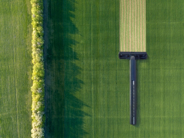 Aerial view from a drone above green agricultural field with shaving process by disposable shaving machine. Natural creative background.