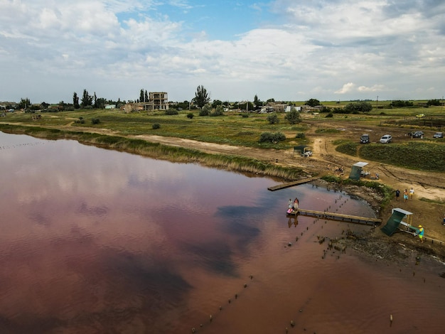 Aerial view from a drone on people who bathe in dirty water rusty color outdoor