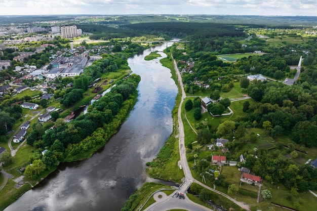 Aerial view from great height on wide river and huge bridge of old city