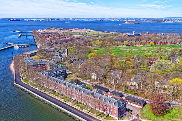 Aerial view from helicopter on Governors Island in Upper New York Bay. New York City, USA. Liberty Island is on the background