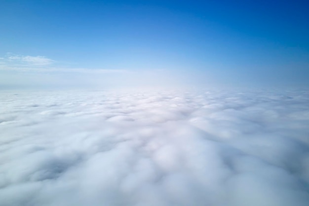 Aerial view from high altitude of earth covered with puffy rainy clouds forming before rainstorm