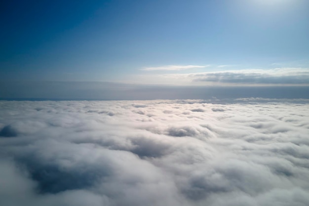 Aerial view from high altitude of earth covered with puffy rainy clouds forming before rainstorm