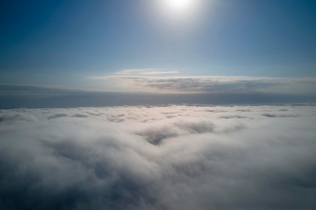 Aerial view from high altitude of earth covered with puffy rainy clouds forming before rainstorm