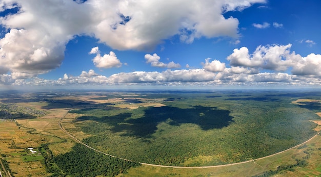 Aerial view from high altitude of earth covered with white puffy cumulus clouds on sunny day