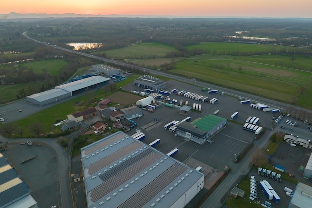 Aerial view of goods warehouses and logistics center in industrial city zone from above