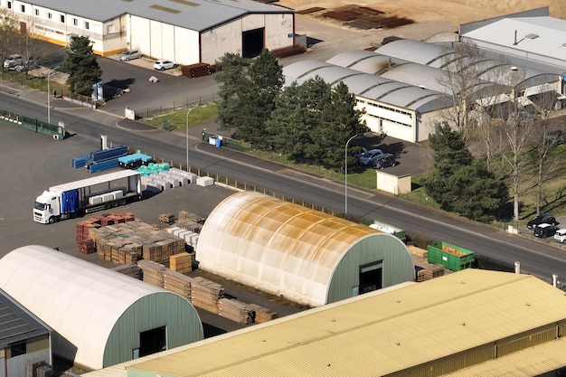 Aerial view of goods warehouses and logistics center in industrial city zone from above