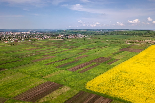 Aerial view of green, plowed and blooming fields