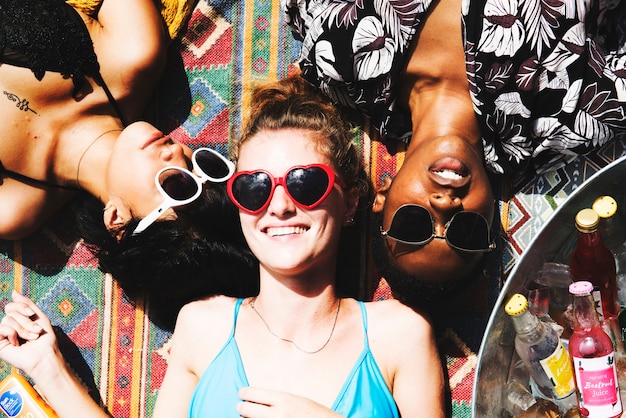 Aerial view of a group of female friends lying under the sun