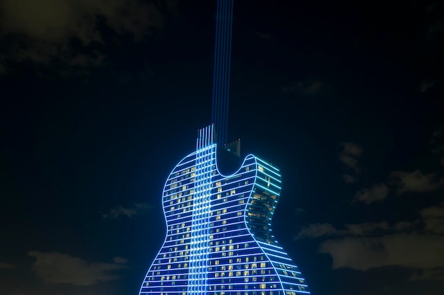 Aerial view of guitar shaped Seminole Hard Rock Hotel and Casino structure illuminated with bright neon colorful lights in Hollywood Florida Miami USA May 8 2023