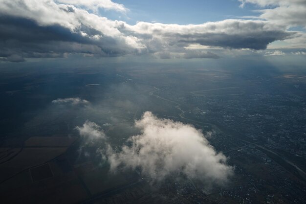 Aerial view at high altitude of earth covered with puffy cumulus clouds forming before rainstorm